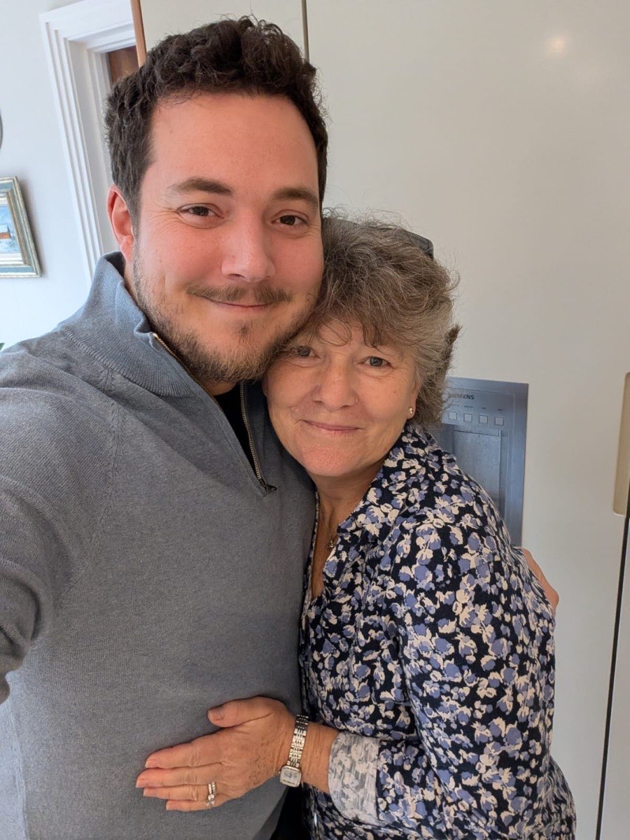 Luke and his mum, cheek to cheek, both smiling